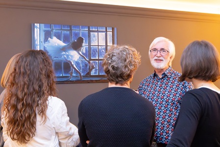 Ausstellung "Im Licht 2026" im Café Rosé in Karlsruhe. Bernd Hentschel erläutert ein Bild